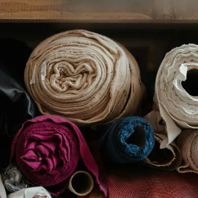 bundles of fabric on a shelf